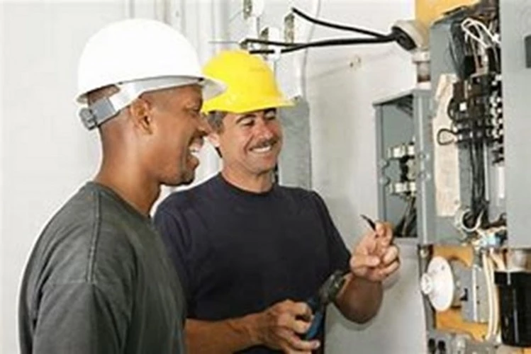 Picture of two Electrical Contractors reviewing a breaker panel