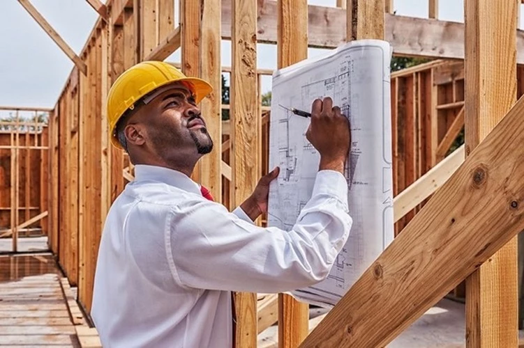 Image of a Home Inspector reviewing plans of a new construction home